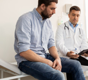 A man sitting next to a docter